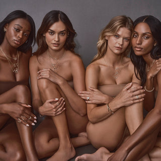 4 models sitting leaning on each other wearing constellation collection
