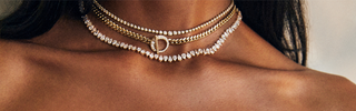 Close up of diamond necklaces layered on a models neck